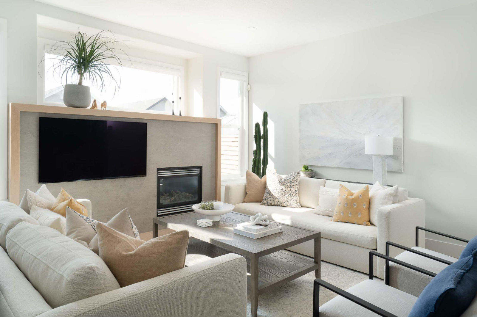 Modern living room design highlighting custom fireplace finishes, neutral plush seating, and warm wooden accents.