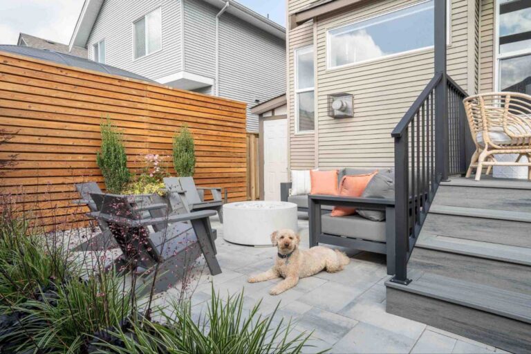Modern outdoor patio featuring a fire pit, composite deck, wood privacy fence, and lounge seating planned during home pre-construction.