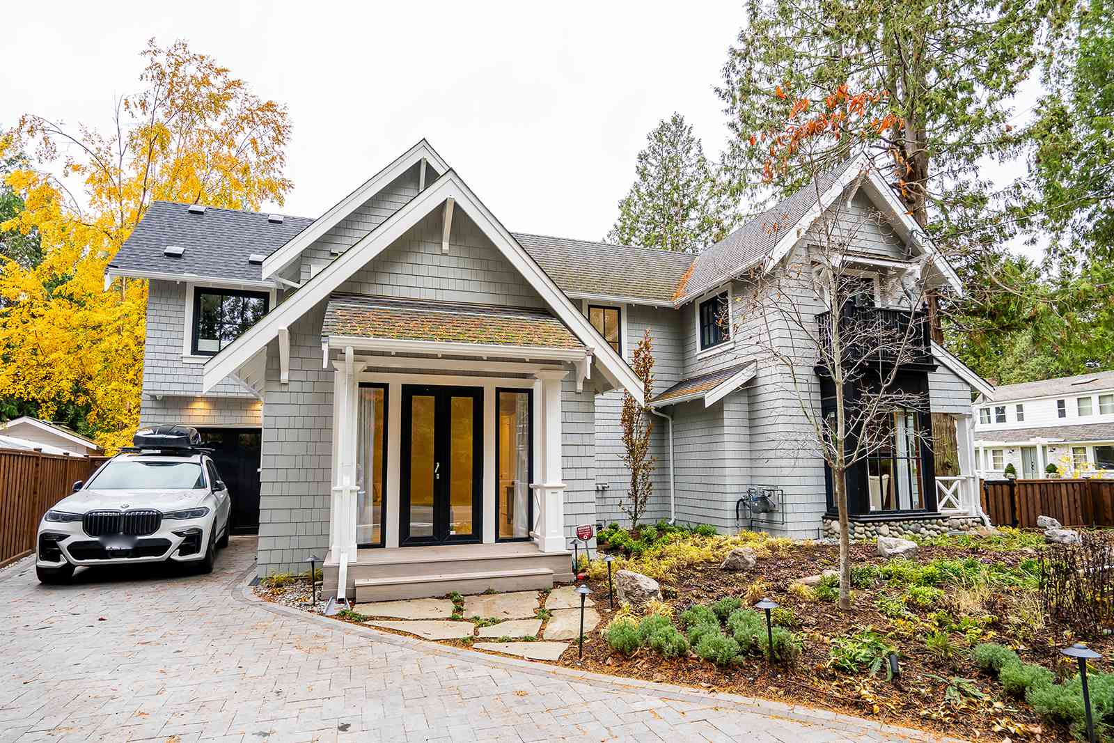 Exterior front view of a grey shingle home considered for a pre-purchase renovation consultation walkthrough.